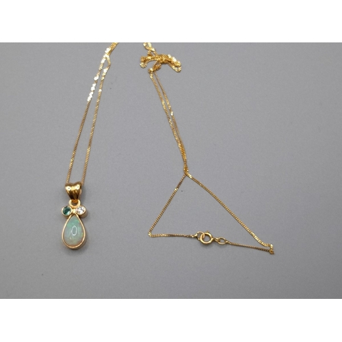 An unusual, unmarked gold gem set pendant, the teardrop shaped opal with single emerald and diamond mounted above. Hung on 14ct chain. Weight approx. 2.9g