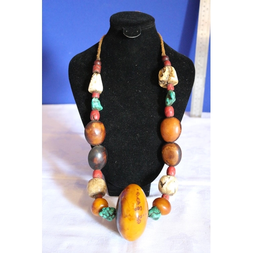 28 - Multi Stone Necklace with Tibetan Turquoise and a Large Round Copal Amber Centerpiece.