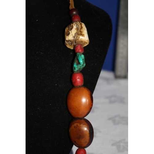 28 - Multi Stone Necklace with Tibetan Turquoise and a Large Round Copal Amber Centerpiece.