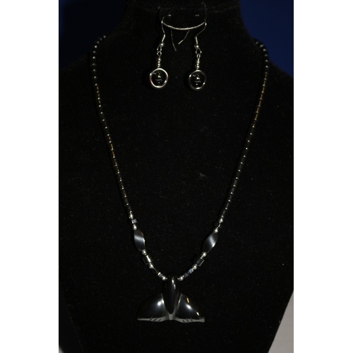 543 - A Modern Pendent Necklace with a Whales Tail Design and Matching Earrings - Main Colour is Graphite ... 