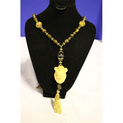 668 - Tigers Eye Long Necklace with Chinese Figures Head made from Wood