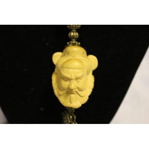 668 - Tigers Eye Long Necklace with Chinese Figures Head made from Wood