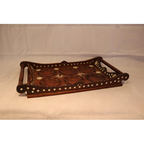 15 - Heavily embossed vintage twin handled wooden tray with what might be mother of pearl inlay