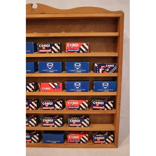 179 - A bespoke wooden cabinet containing 37 boxed diecast miniature Corgi vehicles