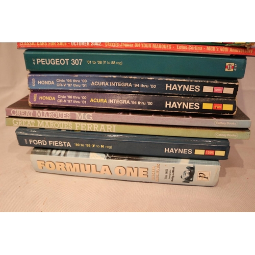 198 - A selection of motoring books and manuals including 12 Haynes manuals. Motoring Fan and clock