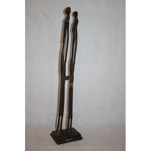 221 - Heavy metal sculpture of African couple