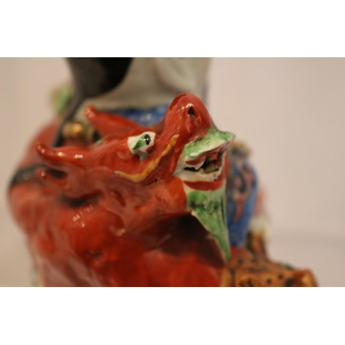 77 - Chinese emperor figure showing five toed dragon. slightly chipped horn