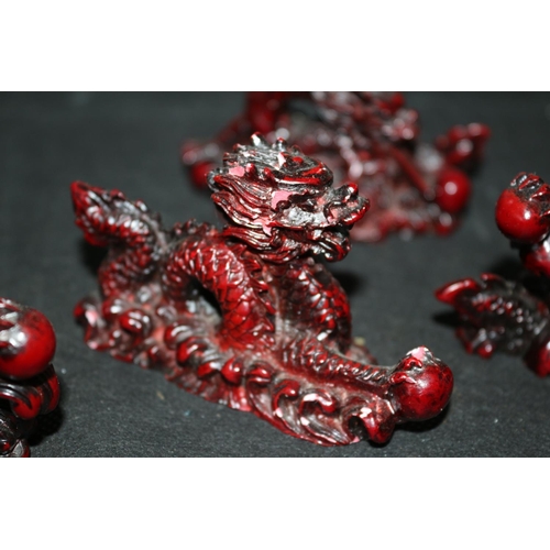 117 - A Collection Of 5 Red Composite Dragons All Holding Pearl Of Wisdom