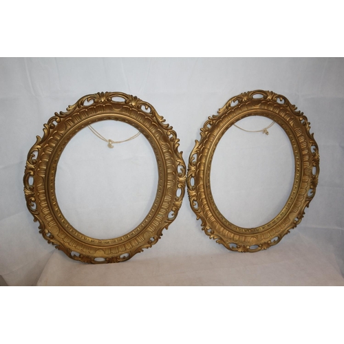 29 - Two Gold Coloured Oval Picture Frames. 66 cm tall