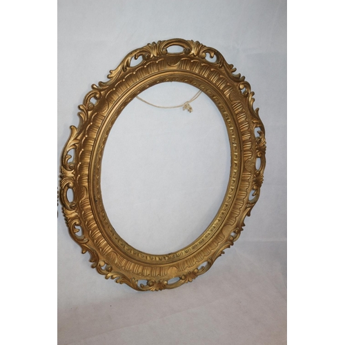 29 - Two Gold Coloured Oval Picture Frames. 66 cm tall