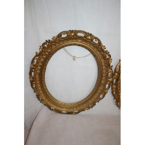 29 - Two Gold Coloured Oval Picture Frames. 66 cm tall