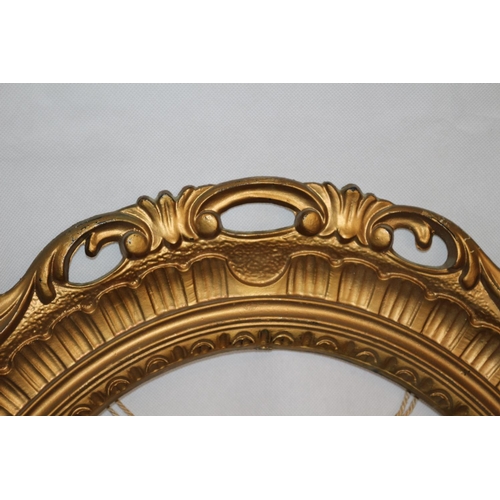 29 - Two Gold Coloured Oval Picture Frames. 66 cm tall