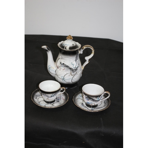 5 - A Decorative Coffee pot with 2 Cups and Saucers with a Dragon Pattern