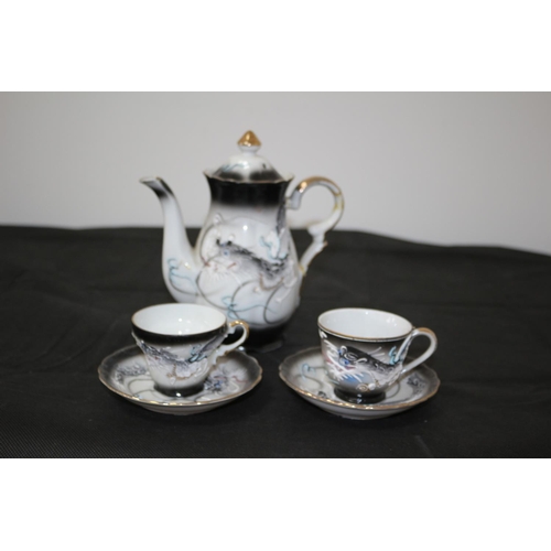 5 - A Decorative Coffee pot with 2 Cups and Saucers with a Dragon Pattern