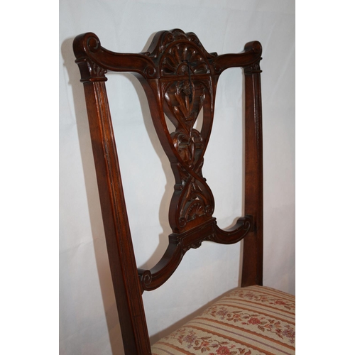 54 - Two nursery chairs with ornate carved backs complete with original casters