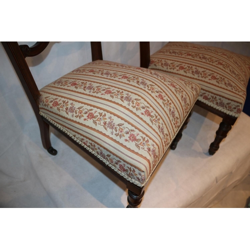 54 - Two nursery chairs with ornate carved backs complete with original casters