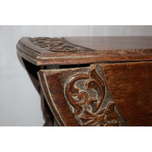 75 - Highly Carved Drop Leaf serving table. Aged