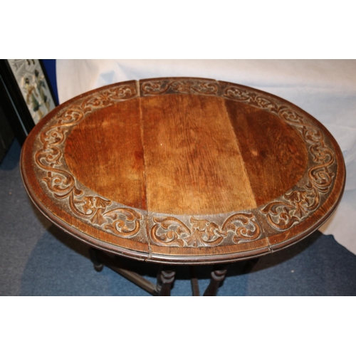 75 - Highly Carved Drop Leaf serving table. Aged