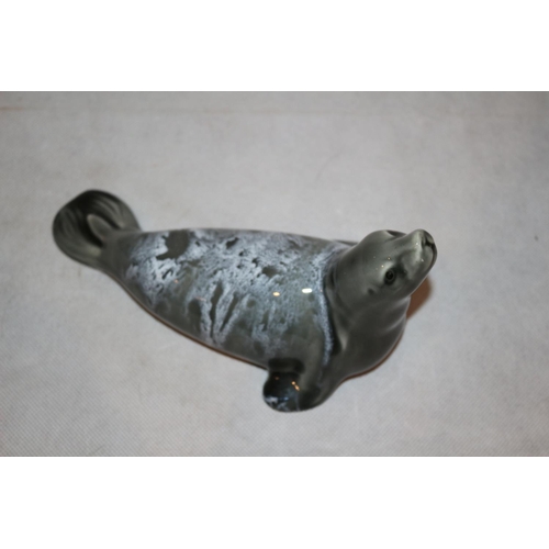 78 - A Large Poole pottery dolphin and an unmarked Seal statue