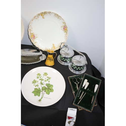 179 - An Eclectic Mix of Assorted Items Including Flatware, Lazey Susan, Plates by Alfred Meakin and a Man... 