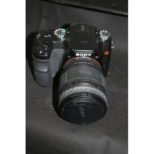 196 - A Sony a100 Camera with Sigma Lens 70-210 1-4/56 Also Comes With Guide Manual, Charger, 2 Batteries ... 