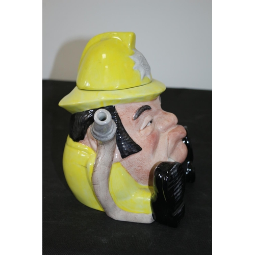 231 - 3 Teapots Including a Grumpy Looking Staffordshire Fireman, A Royal Doulton Carmel, and a Biltons of... 