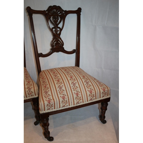 311 - Two nursery chairs with ornate carved backs complete with original casters