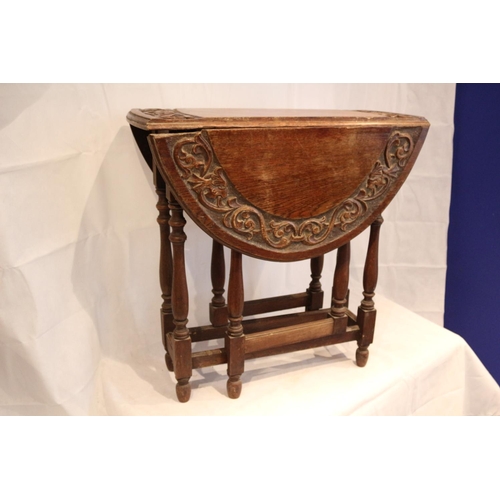 317 - Highly Carved Drop Leaf Oval serving table. Aged