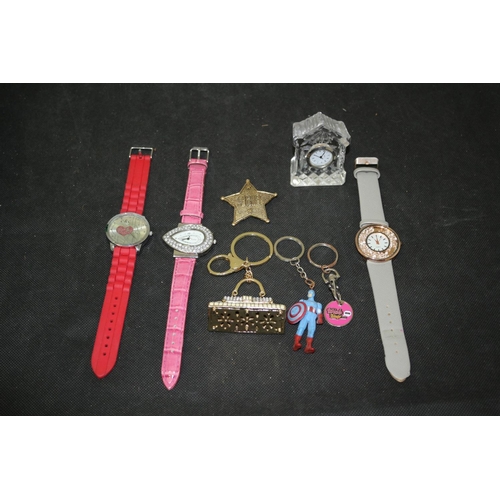 515 - 3 Wrist Watches A Small Crystal Clock and Some Key Rings