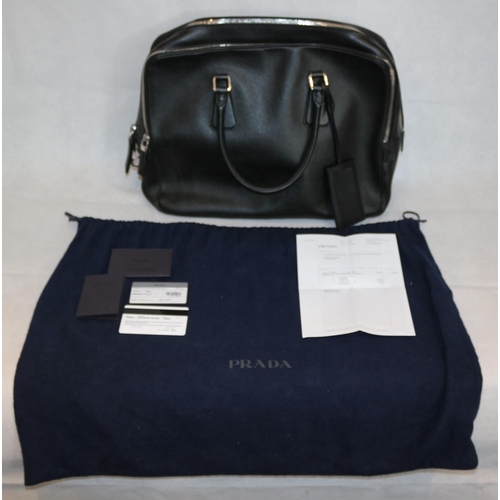 542 - Prada Handbag With Documentation And Dust Bag. Some Small Scuffing