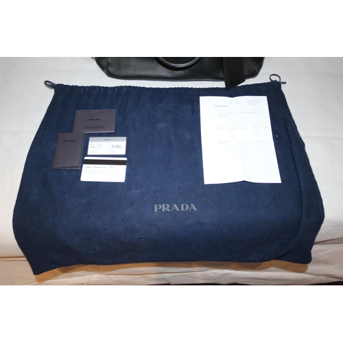 542 - Prada Handbag With Documentation And Dust Bag. Some Small Scuffing