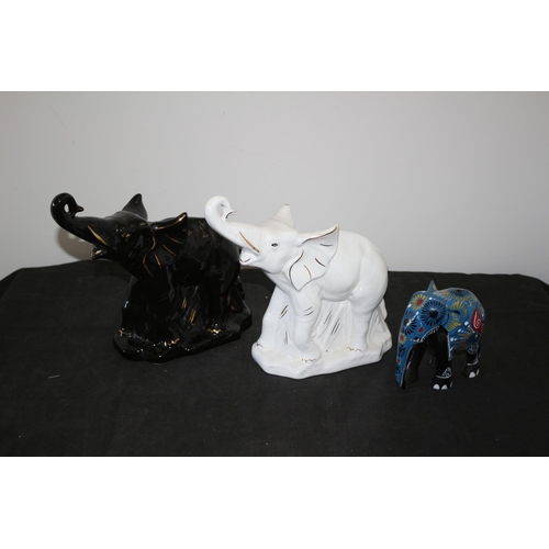 550 - A Selection of Elephants 2 china and 1 wooden white china elephant has slight chip to ear