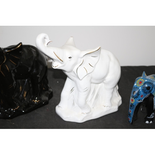 550 - A Selection of Elephants 2 china and 1 wooden white china elephant has slight chip to ear