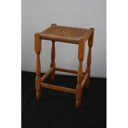 28 - A Tall Mid Century Foot Stool with Wicker Woven Rattan and Wood turned Legs