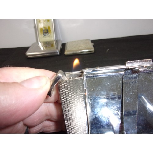 250 - A Mixed Of Tobacciana Including Two Gas Lighters, One With An Audi Theme The Other With Manchester C... 