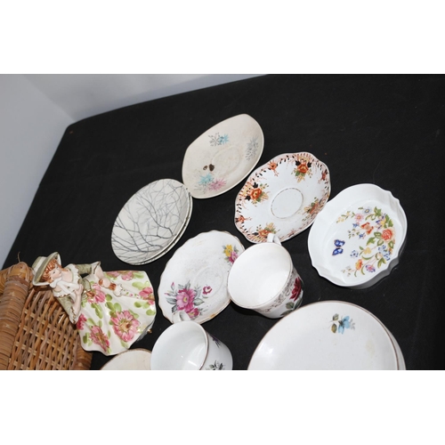 611 - Wicker Basket with Large Selection of Saucers and Tea-Plates, 2 x Cups and a Figurine