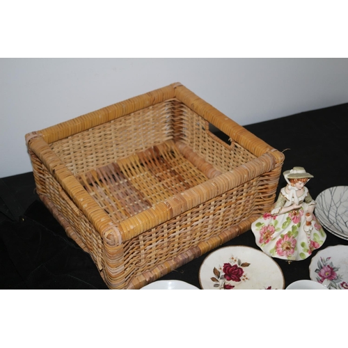 611 - Wicker Basket with Large Selection of Saucers and Tea-Plates, 2 x Cups and a Figurine