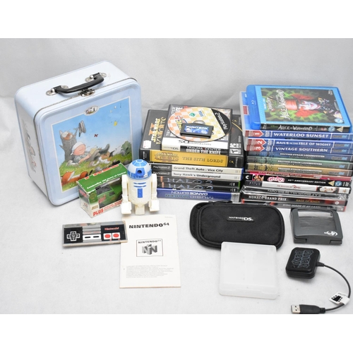 127 - DVD's, A Metal Tin with a Cup and Saucer and gaming Items and a Model Van