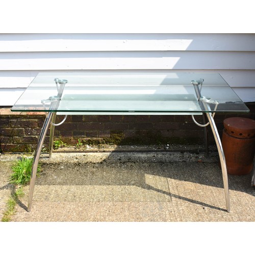 279 - A Glass And Chrome Desk / Table With Undershelf. 140cm x 80cm x 73cm Height.