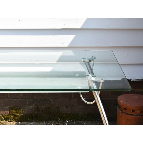 279 - A Glass And Chrome Desk / Table With Undershelf. 140cm x 80cm x 73cm Height.