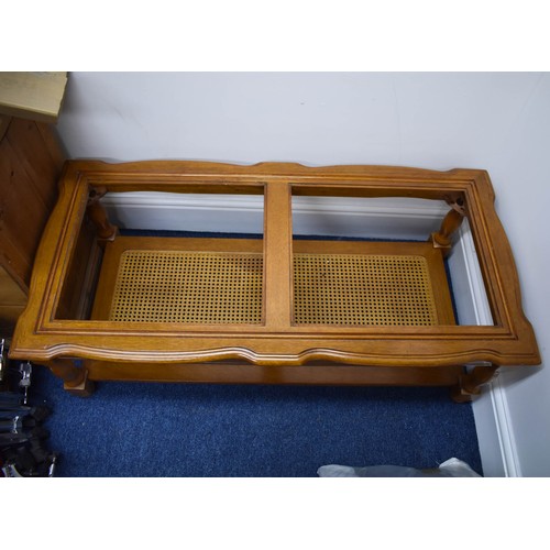 348 - A Vintage Rectangular Coffee Table Featuring A Rattan Under Shelf And A Glass Top. 45cm x 118cm.