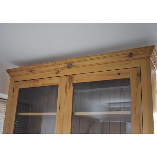 352 - A Large Pine Glazed Display Cabinet. 136cm Width x 20cm Deep x 143cm High.