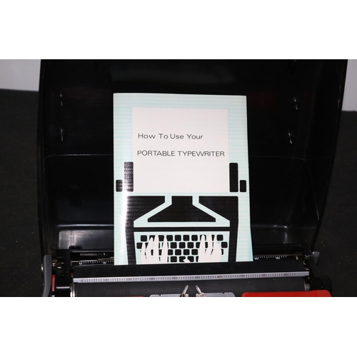 115 - A Brother Deluxe 220 Typewriter from 1982 with Handbook and Warranty Card