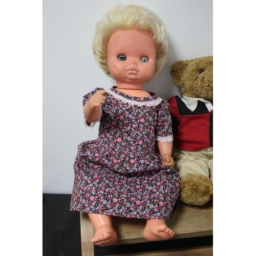 120 - A Teddy Bear in a Rugby Top, Doll in a Floral Dress and a Wooden Step