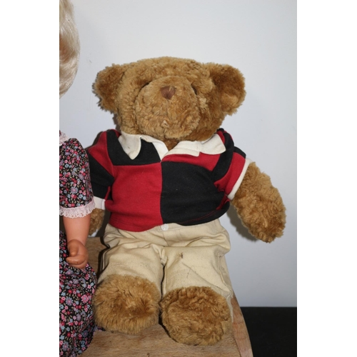 120 - A Teddy Bear in a Rugby Top, Doll in a Floral Dress and a Wooden Step