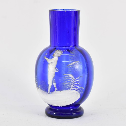 321 - A Mary Gregory Bristol Blue Glass Vase Featuring White Decoration. 11.5cm Height.