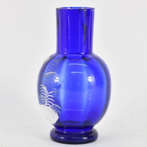 321 - A Mary Gregory Bristol Blue Glass Vase Featuring White Decoration. 11.5cm Height.