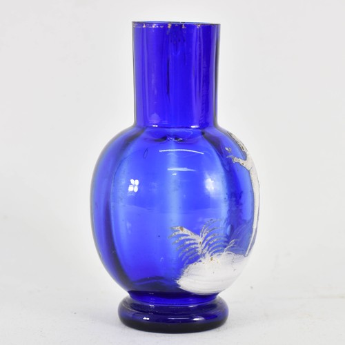 321 - A Mary Gregory Bristol Blue Glass Vase Featuring White Decoration. 11.5cm Height.