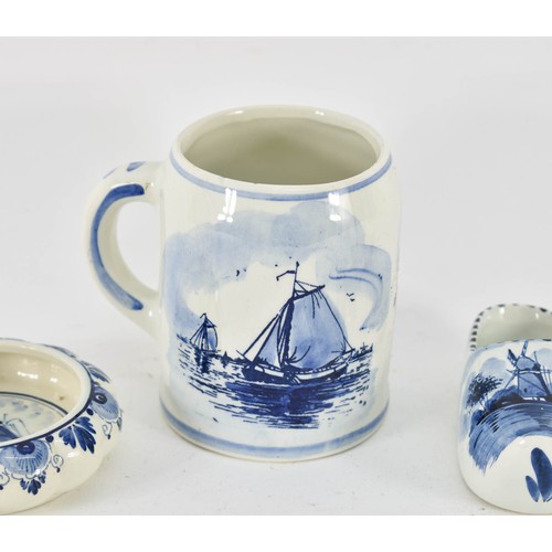 350 - A Collection Of 4 Delfts Blauw Items Depicting Dutch Scenes Including A Cup And Clogs