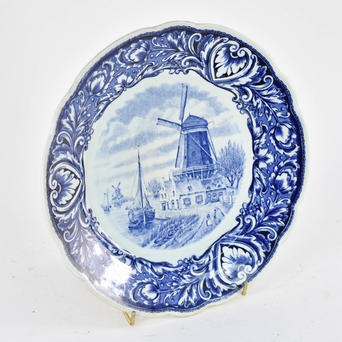 353 - A Delightful Delfts Blauw Wall Plate Featuring A Dutch Windmill Scene. 26cm Diameter.